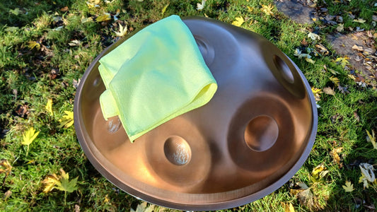 Copper handpan with a green cloth on grass