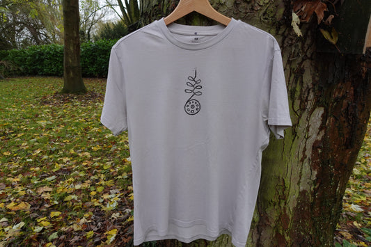Light grey crew-neck T-shirt in size M hanging outdoors, showing the hand-stamped design on the front.