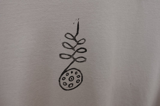 Close-up of the hand-stamped design on the chest, showing natural variations in texture