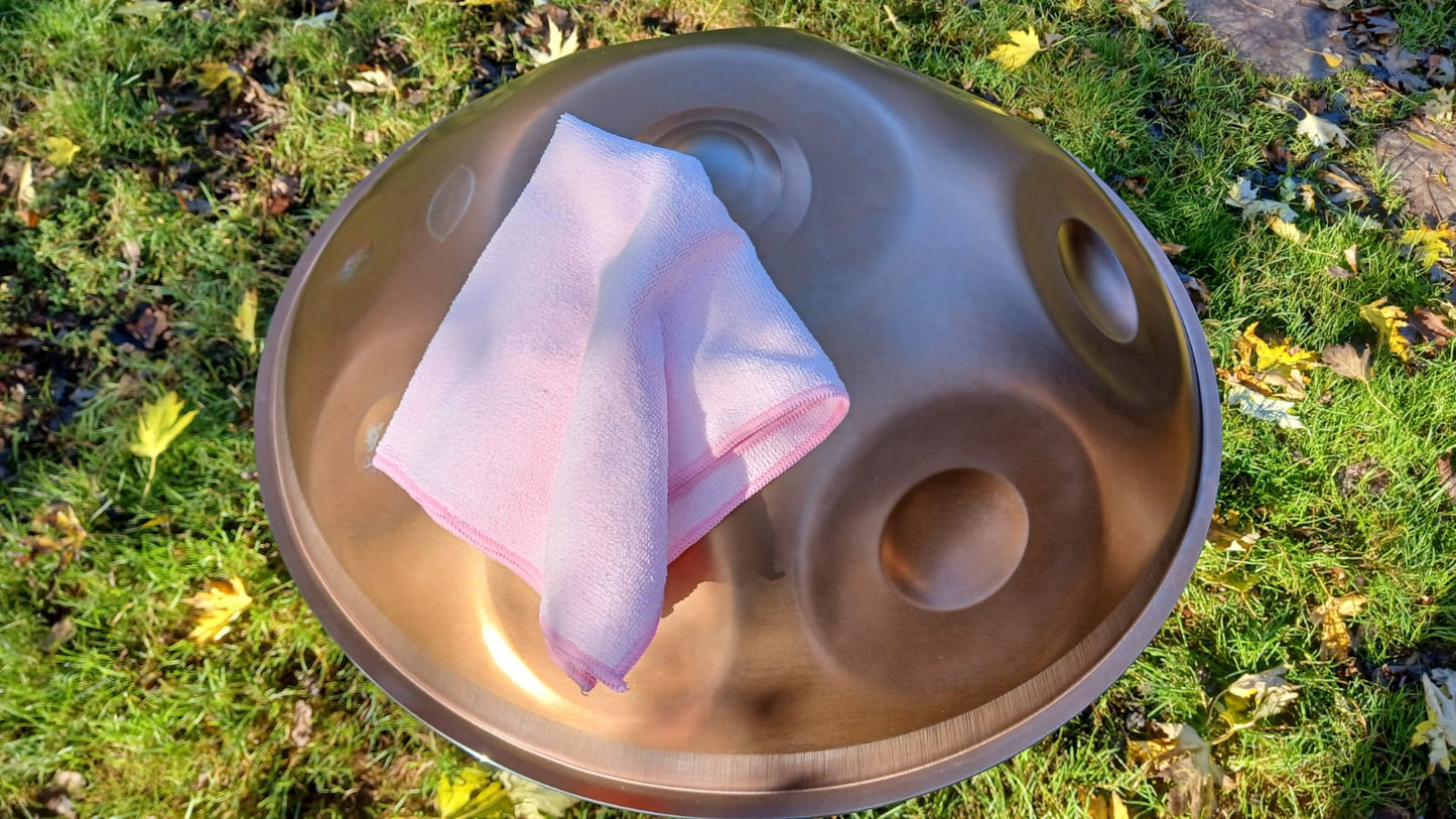 Handpan with a pink cloth on a grassy background