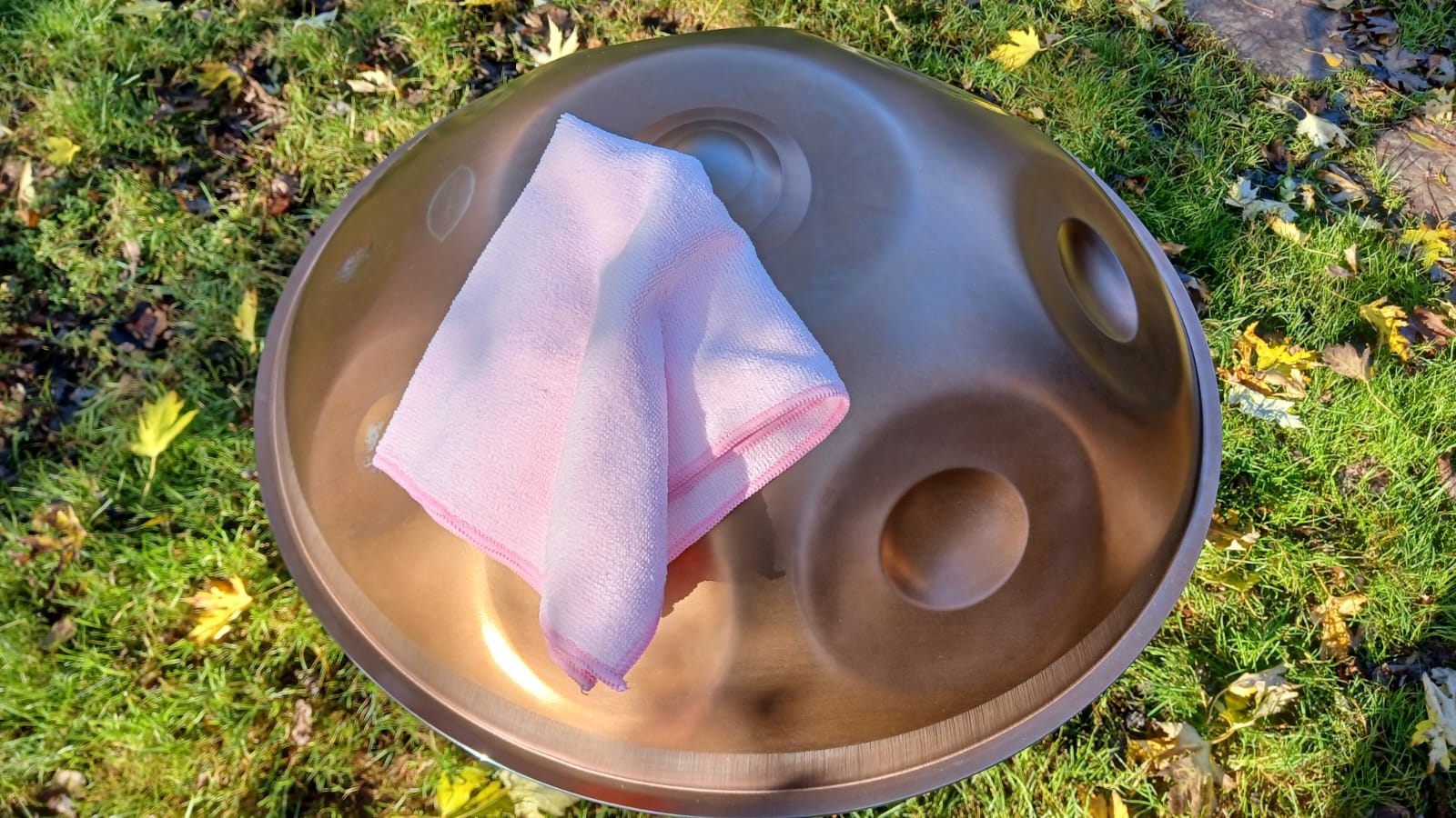 Handpan with a pink cloth on a grassy background