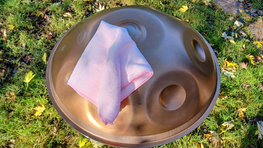 Handpan with a pink cloth on a grassy background