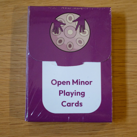 Open Minor Handpan Playing Cards deck by Rosie Bergonzi in purple packaging on wooden surface